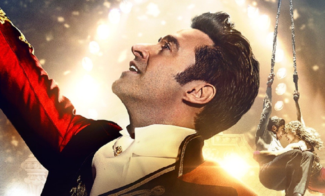 The poster for the film featuring Hugh Jackman in a ring master's outfit surrounded by various circus performers.
