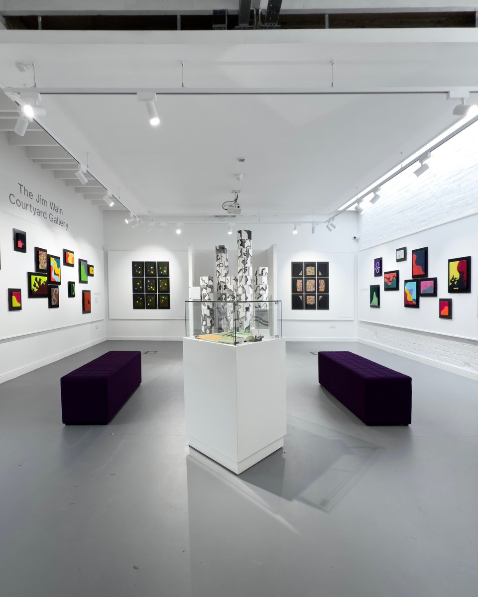 The image shows the art gallery at the Brampton Museum with a display of contempoary textile art