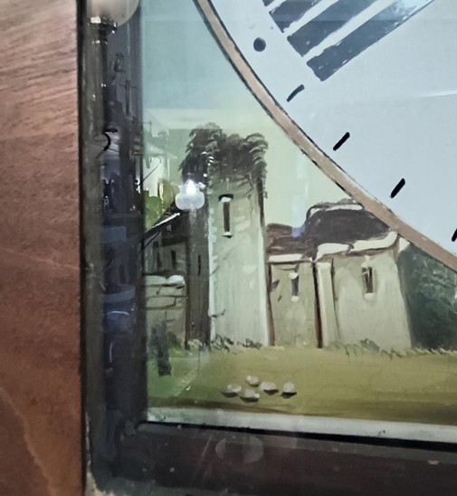 A painting of a castle in the corner of a clock face