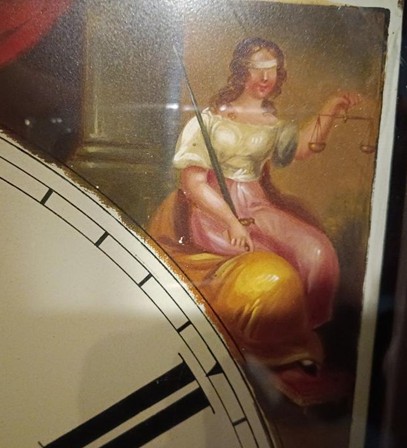 A painting of a seated lady weaing a blindfold and holding scales