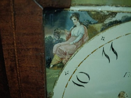 Clock face painting of a seated woman