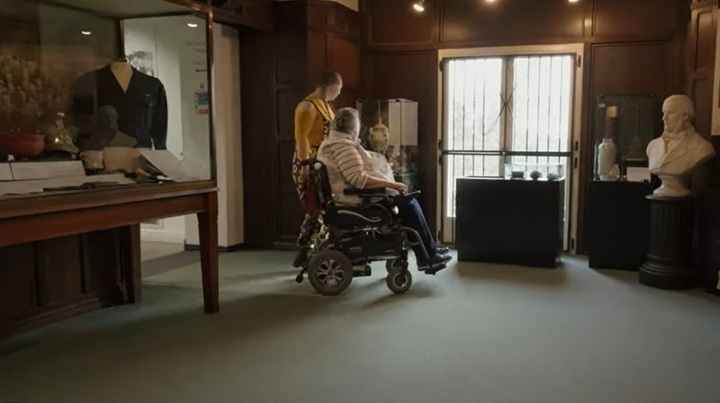 A person using a wheelchair inside a museum gallery