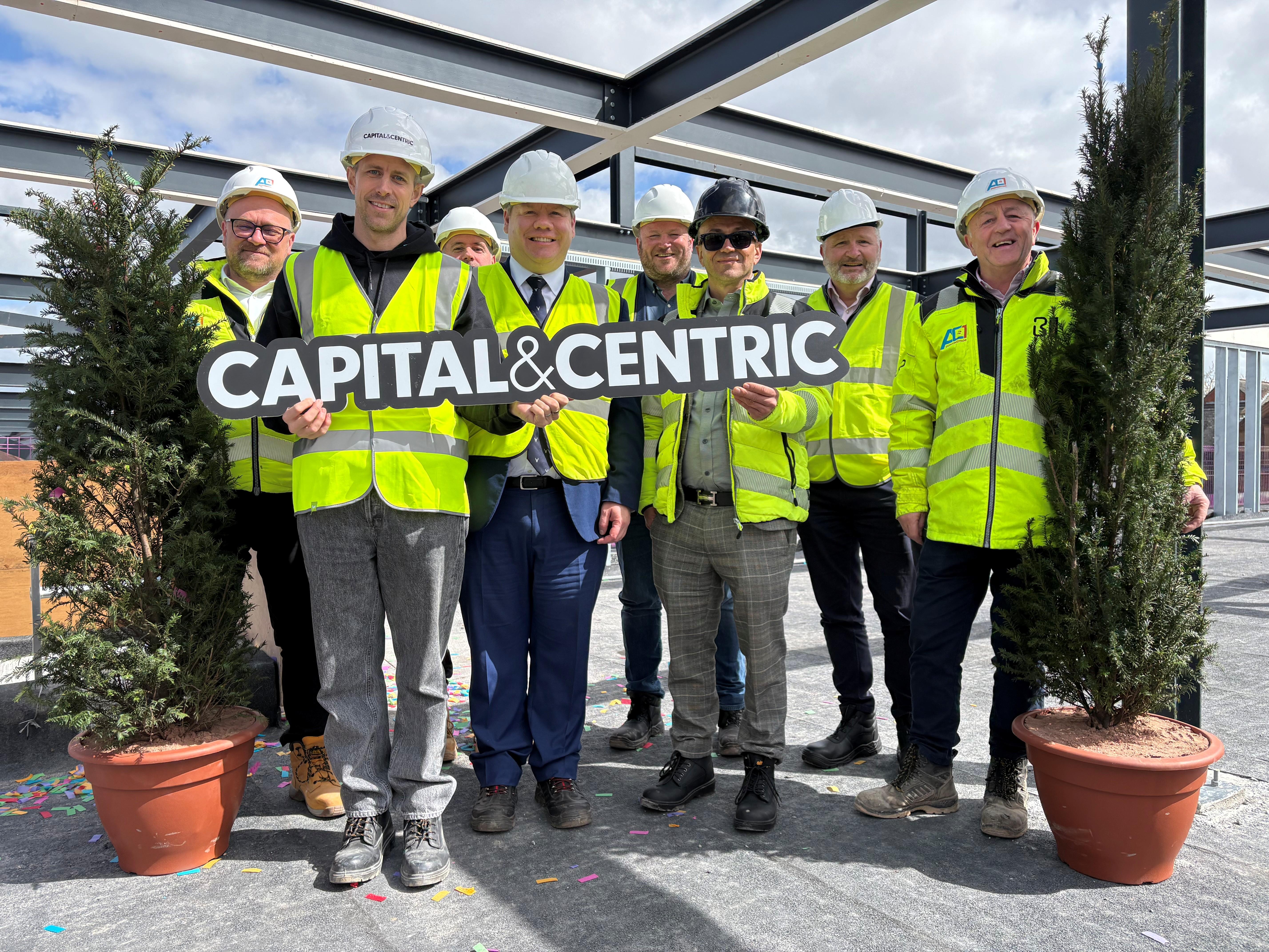 Gordon Mole, the council’s Chief Executive, and Simon McEneny, Deputy Chief Executive, are pictured (fourth and seventh from left) at the topping out ceremony with representatives from Capital & Centric and AC1 Construction.
