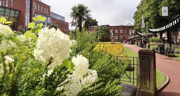Image shows flowers blooming in Queens Gardens.