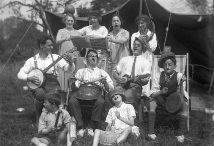 An old photograph showing a group of people camping
