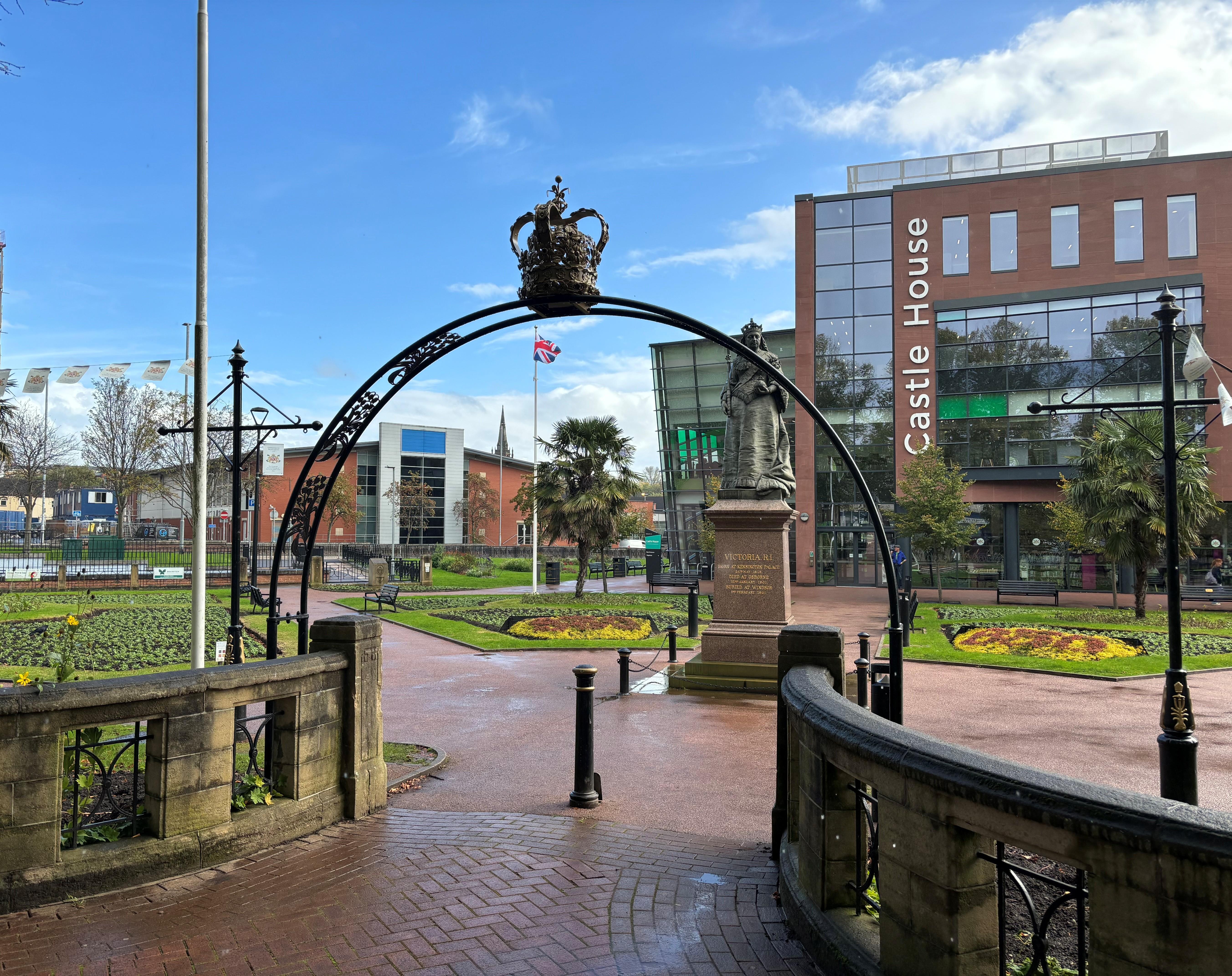 Image shows Queens Gardens in the foreground and the Castle House building beyond.