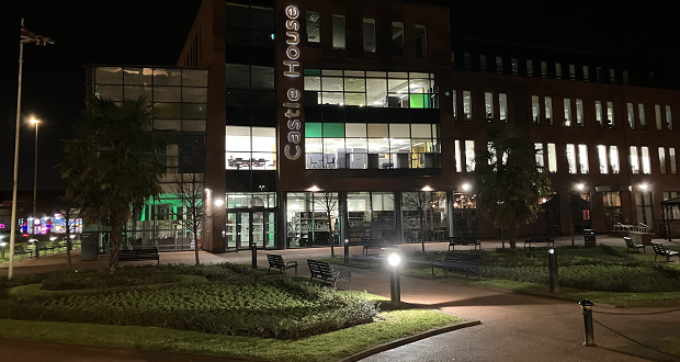 Image shows Castle House at night.