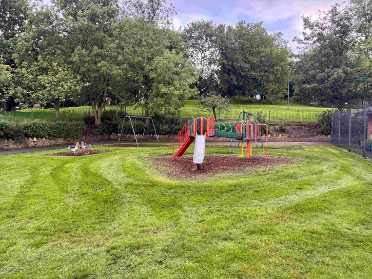 Image of a slide, climbing frame and swing at Chesterton park
