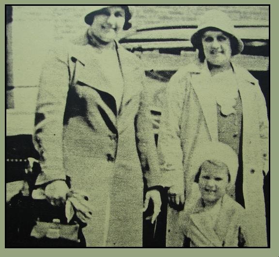 A black and white photo of Clarice Cliff another woman and a small child. They are all smiling and wearing coats and hats. Image used under Creative Commons License, courtesy of www.claricecliff.com