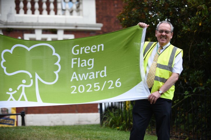 Chris Hollingworth holding green flag award banner