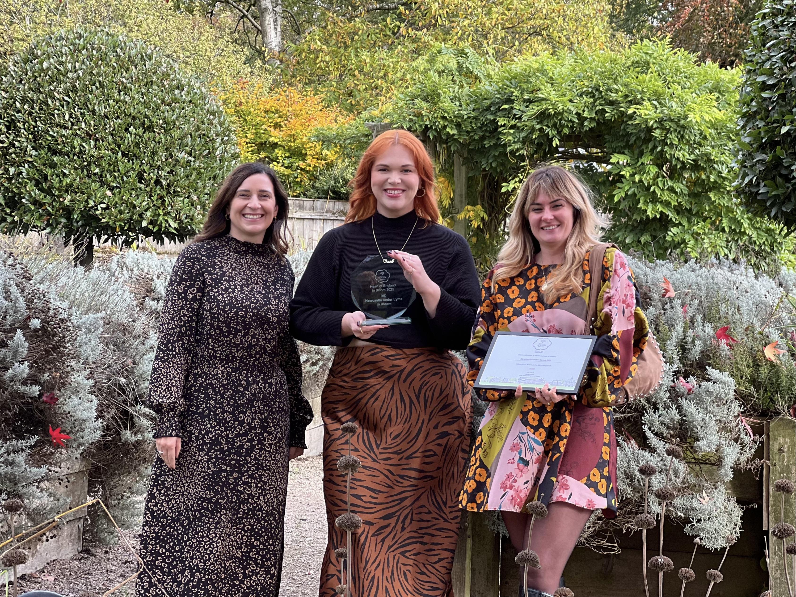 Celebrating the double awards win at the award-winning Brampton Park are Michelle Hopper, the council's Neighbourhood Delivery Manager, and the BID's Charl Pearce and Charlie Machin.