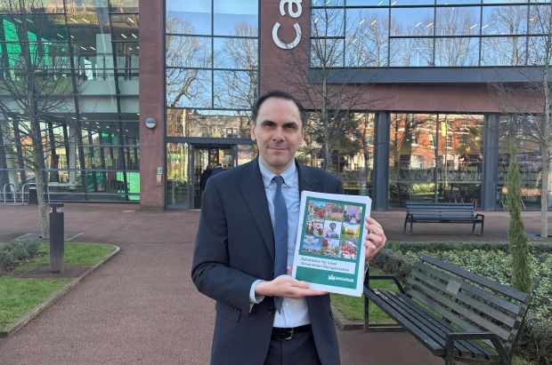 Image shows Council Leader Simon Tagg holding the LGR submission to Government.