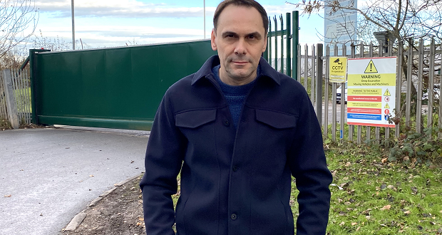 Image shows Council Ledaer Simon Tagg stood outside the closed gates at Walleys Quarry landfill.