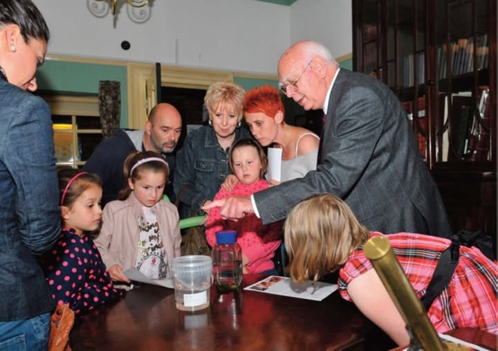 Museum volunteer Stan (far right) showing medicinal leeches to a family in the Victorian Doctor's Surgery