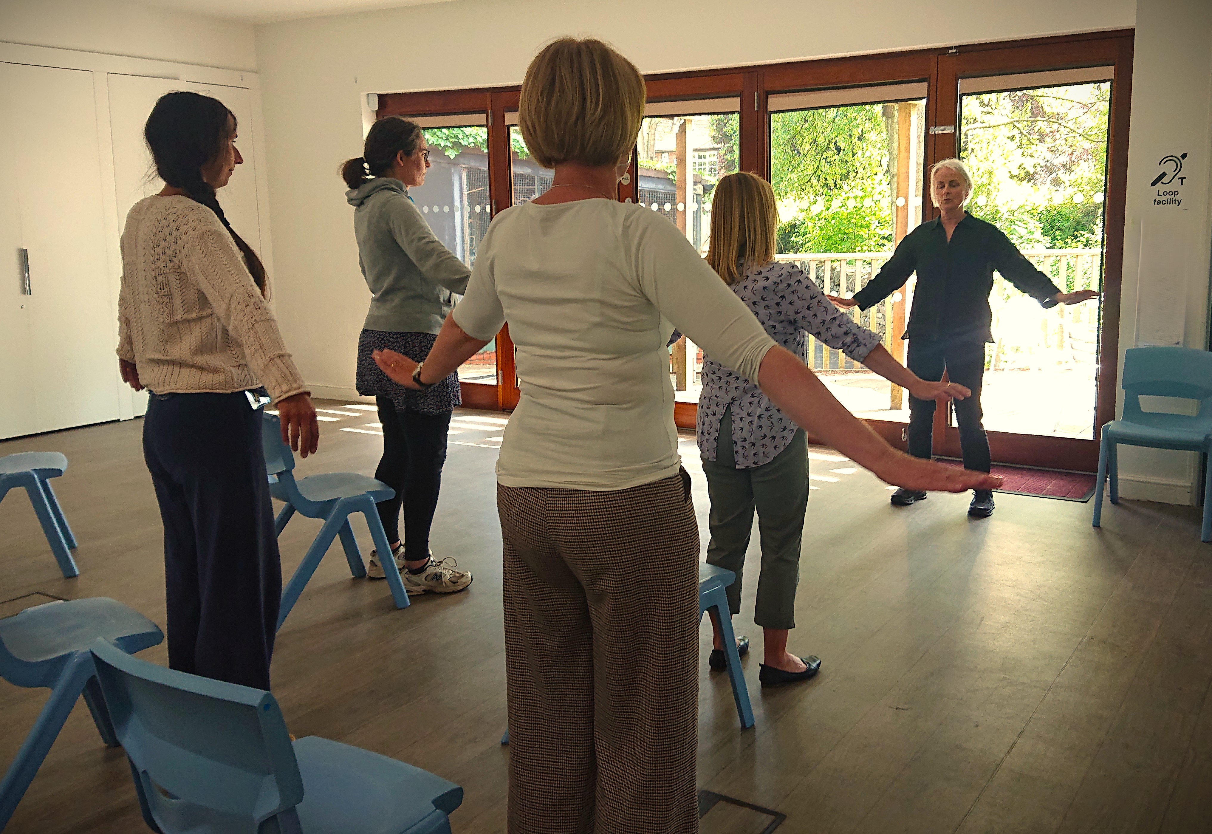 A group of people enjoying a Tai Chi class at the museum