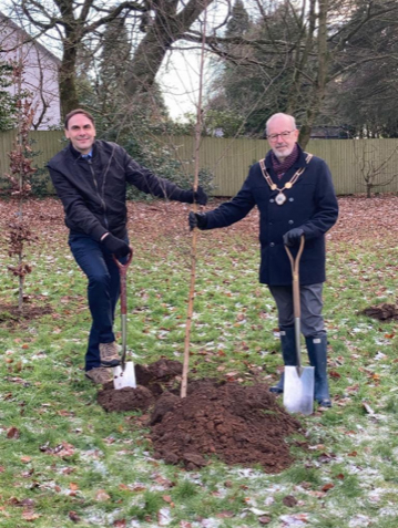 A photo of Simon Tagg and the mayor planting a tree.