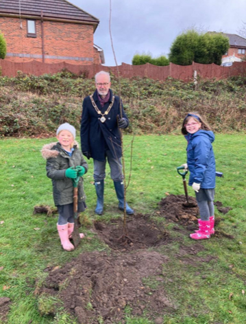 A photo of the mayor and pupils from Thursfield Primary School planting a tree at Newchapel Recreation Ground.