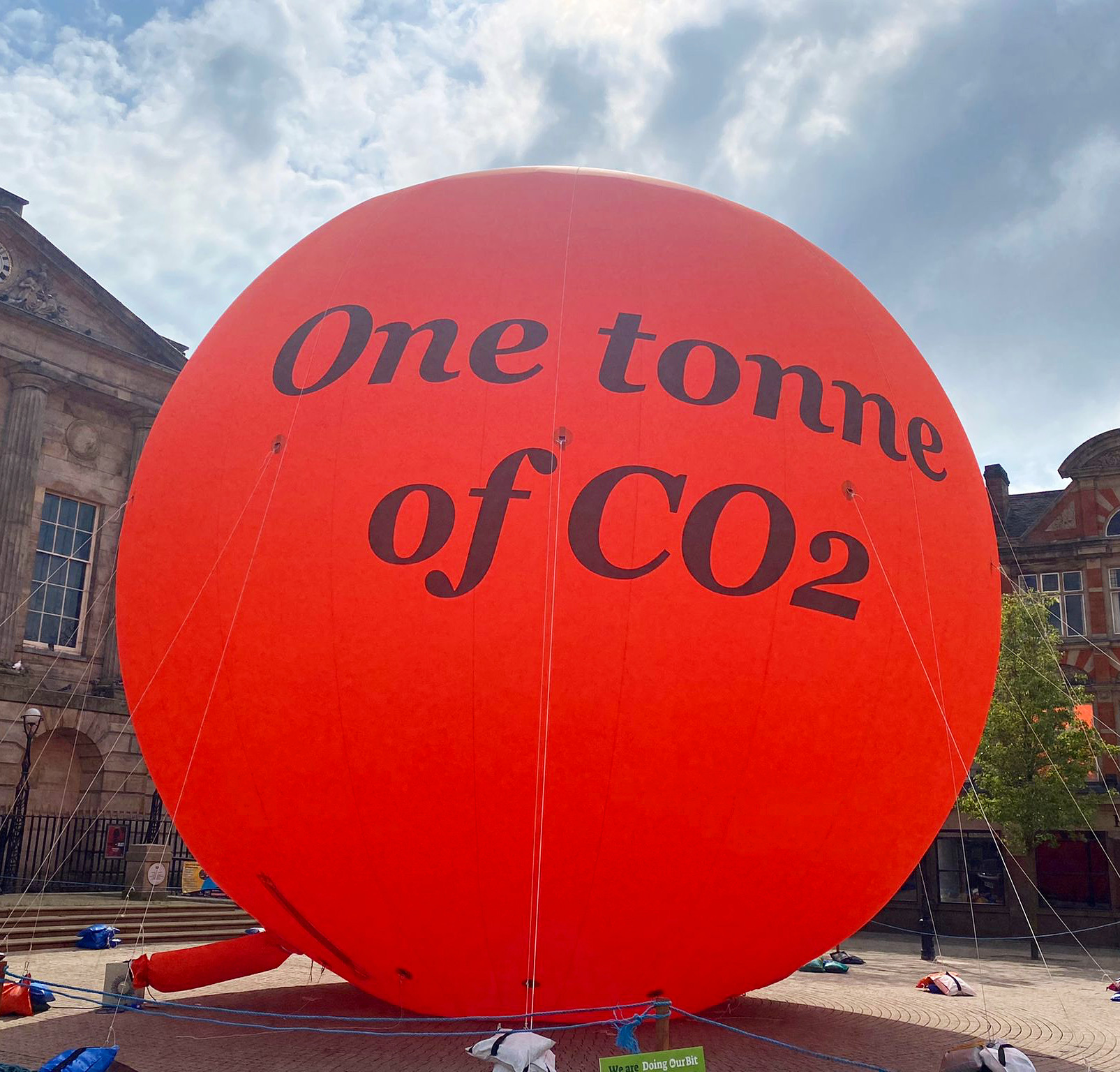 An image of a 10 metre tall orange bubble with the words 'One tonne of CO2' written on it.