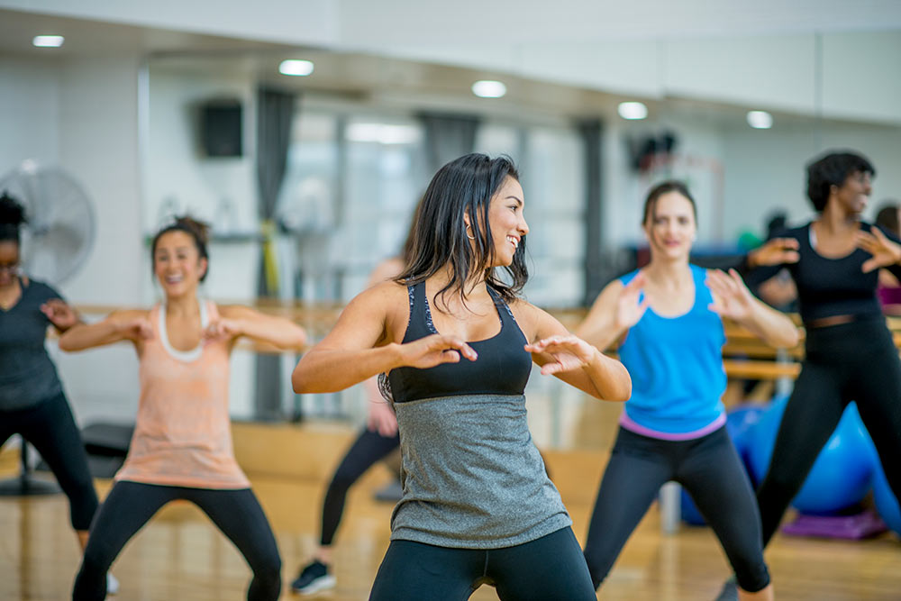 Woman dancing as part of a group exercise class
